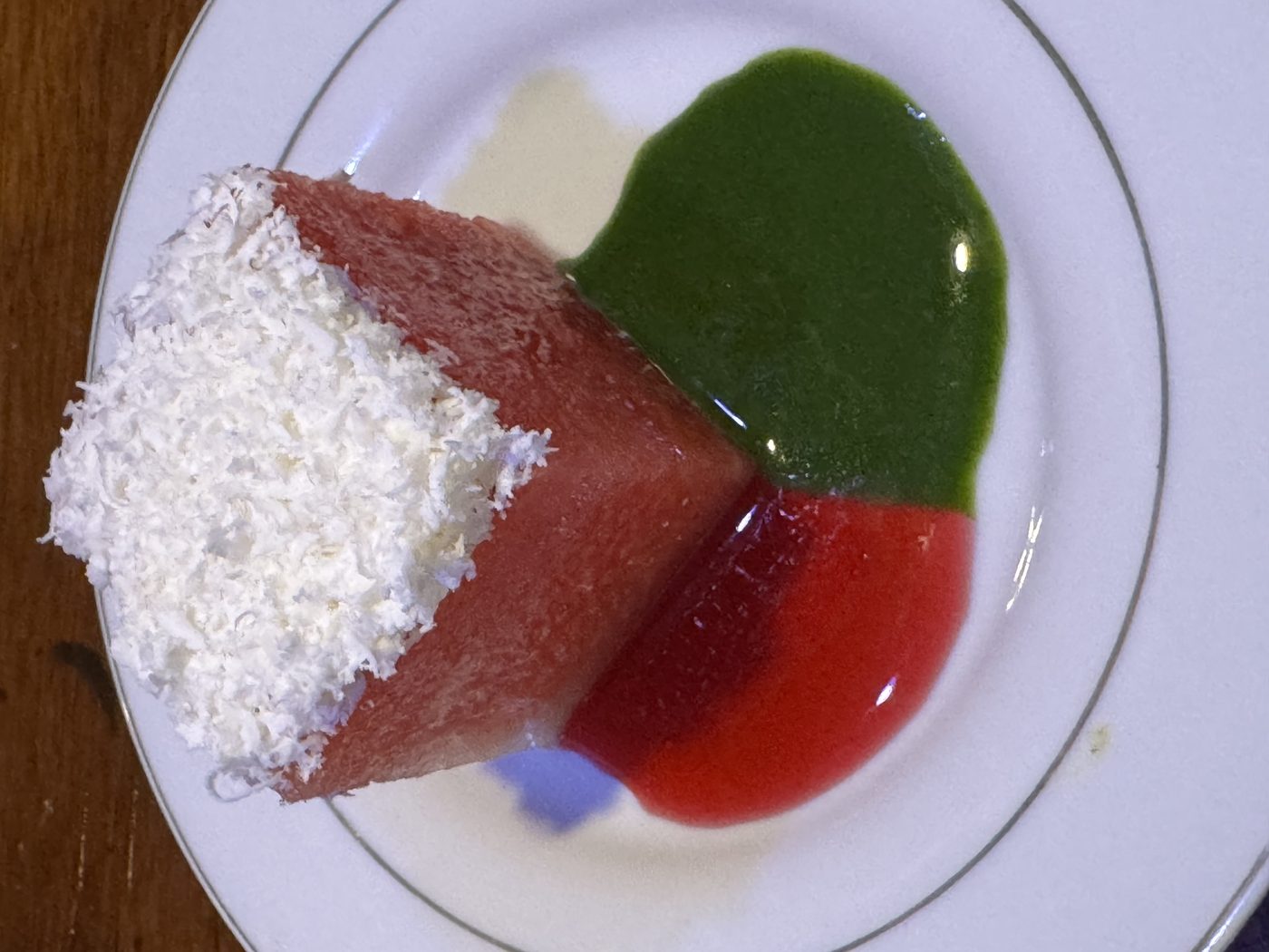 Compressed watermelon with toasted coconut and fruit coulis